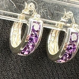 Purple gems set in sterling silver hoop earrings with lever-backs.